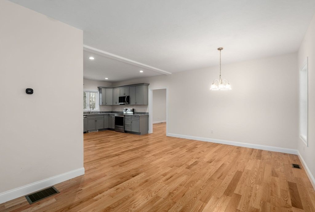 Empty room, Interior, Kitchen, Pendant Lights, Recessed Lighting, Stainless Steel Appliances, Wood Texture Flooring