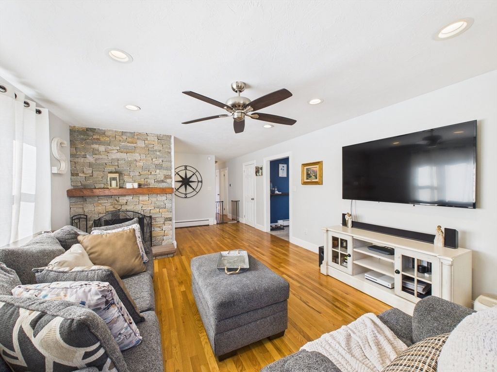 Fireplace, Interior, Living room, Recessed Lighting, Stone Walls, Wood Texture Flooring