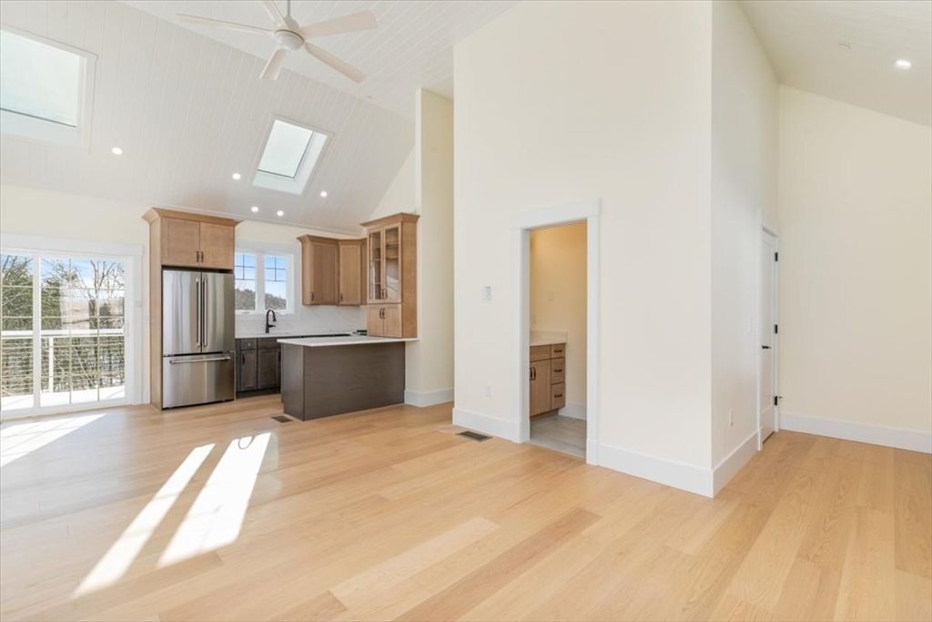 Empty room, Interior, Kitchen, Recessed Lighting, Stainless Steel Appliances, Wood Texture Flooring