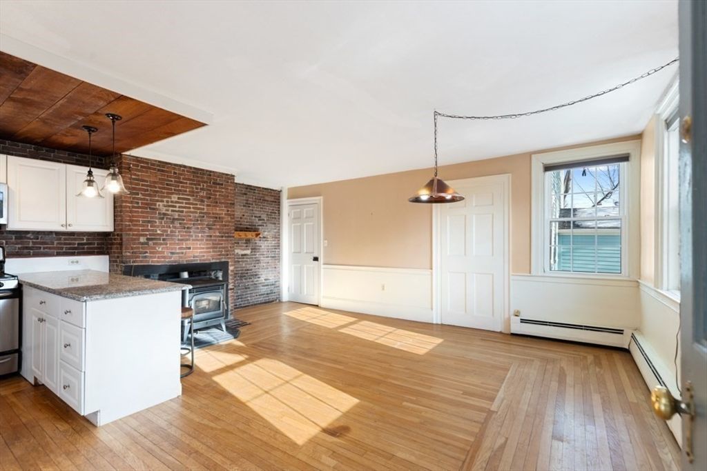 Empty room, Fireplace, Interior, Kitchen, Pendant Lights, Stone Walls, Wood Texture Flooring