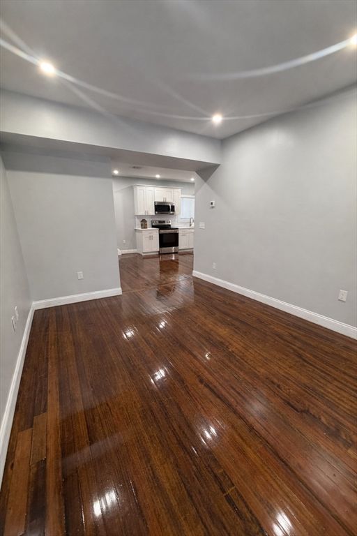 Empty room, Interior, Kitchen, Recessed Lighting, Stainless Steel Appliances, Wood Texture Flooring