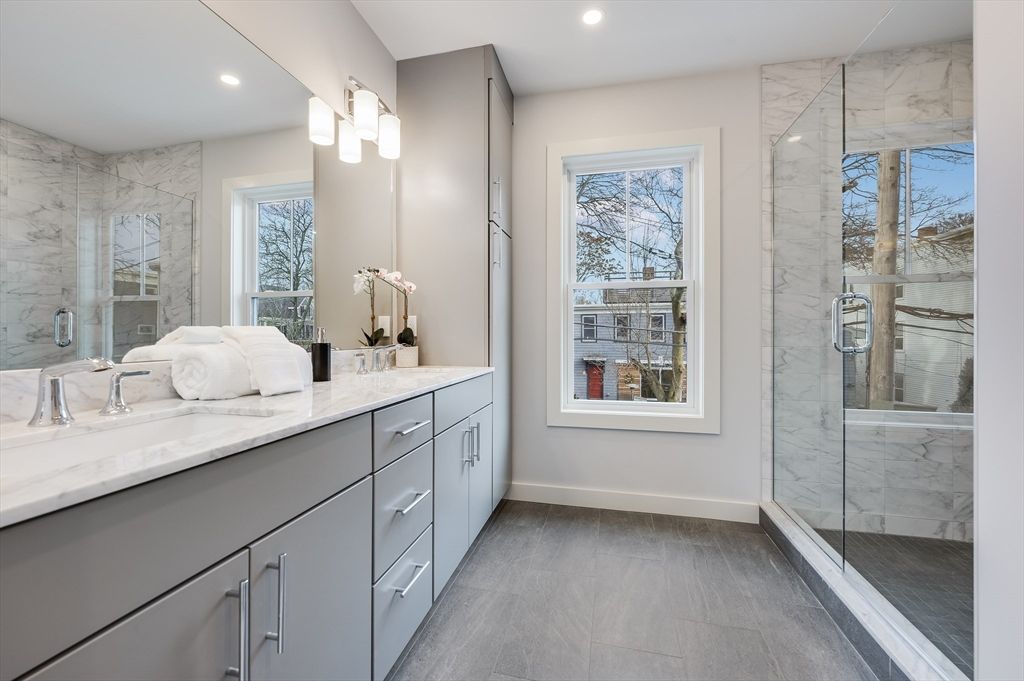 Bathroom, Dual Sink Vanities, Glass Shower, Interior, Marble Walls, Recessed Lighting, Wood Texture Flooring