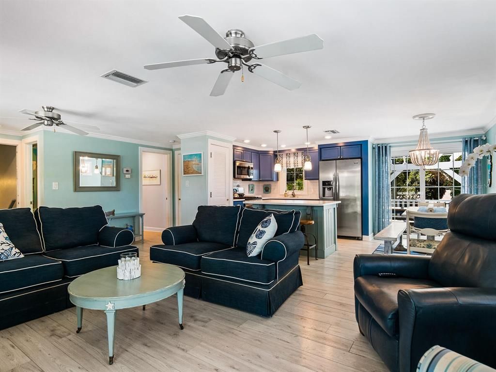 Chandelier, Dining room, Interior, Kitchen, Living room, Pendant Lights, Recessed Lighting, Stainless Steel Appliances, Wood Texture Flooring