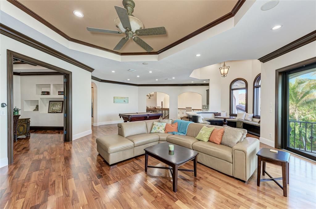 Billiard Table, Chandelier, Game Room, Interior, Living room, Pendant Lights, Recessed Lighting, Wood Texture Flooring