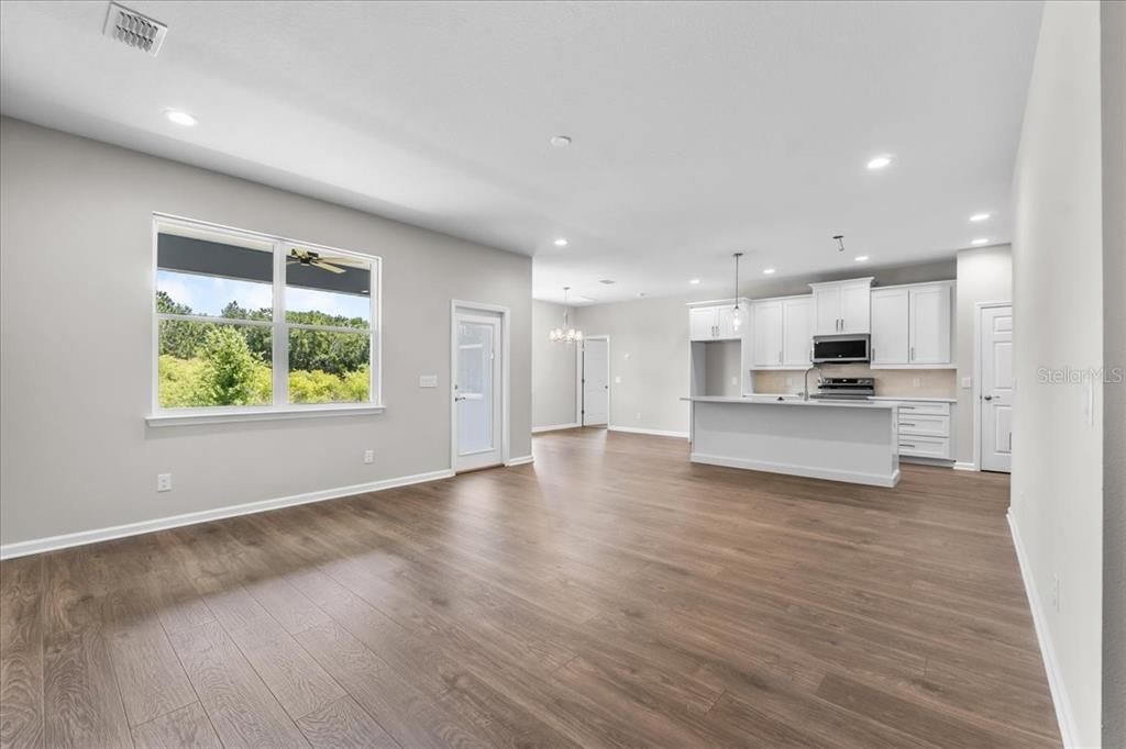 Empty room, Interior, Kitchen, Pendant Lights, Recessed Lighting, Stainless Steel Appliances, Wood Texture Flooring