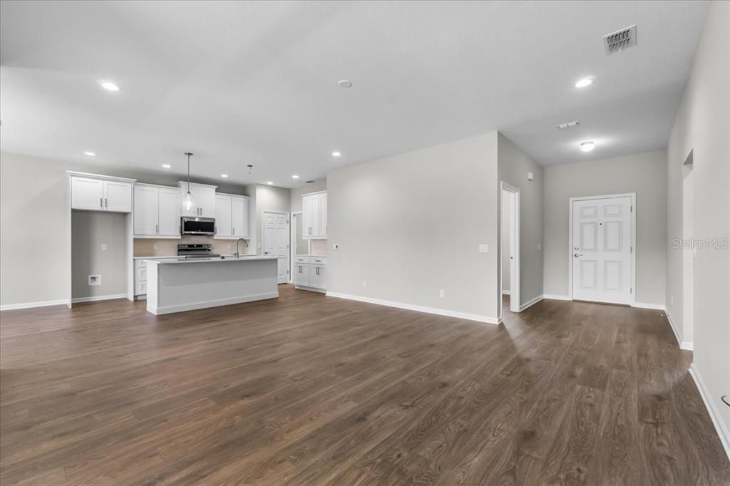 Empty room, Interior, Kitchen, Pendant Lights, Recessed Lighting, Stainless Steel Appliances, Wood Texture Flooring