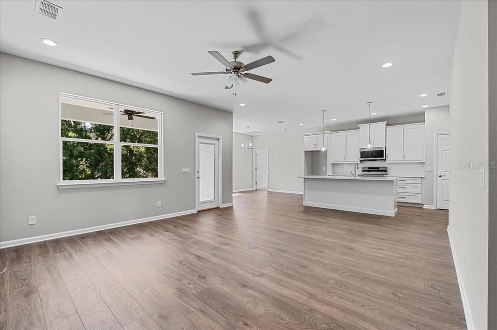 Empty room, Interior, Kitchen, Pendant Lights, Recessed Lighting, Stainless Steel Appliances, Wood Texture Flooring