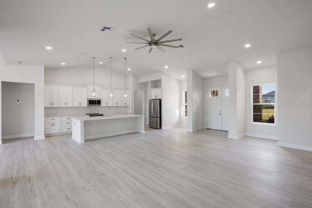 Empty room, Interior, Kitchen, Pendant Lights, Recessed Lighting, Stainless Steel Appliances, Wood Texture Flooring