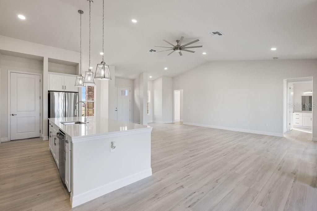 Empty room, Interior, Kitchen, Pendant Lights, Recessed Lighting, Stainless Steel Appliances, Wood Texture Flooring