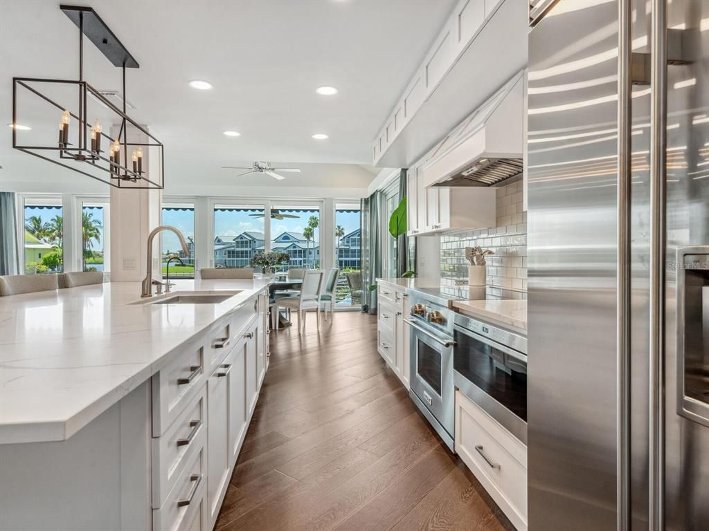 Chandelier, Dining room, Interior, Kitchen, Pendant Lights, Recessed Lighting, Stainless Steel Appliances, Wood Texture Flooring