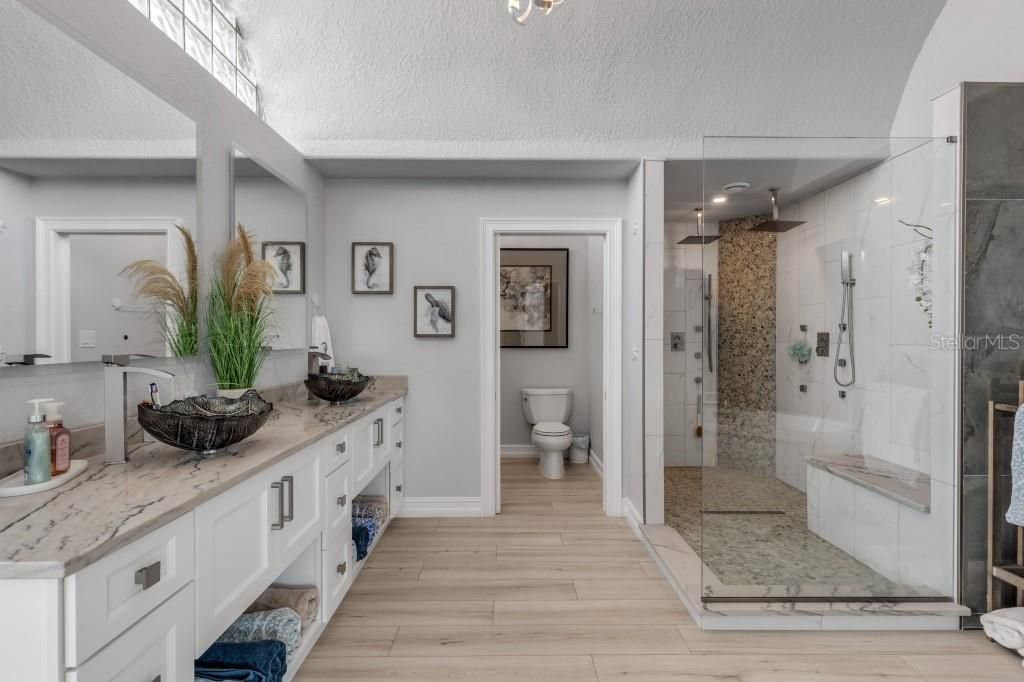 Bathroom, Glass Shower, Interior, Marble Walls, Recessed Lighting, Wood Texture Flooring