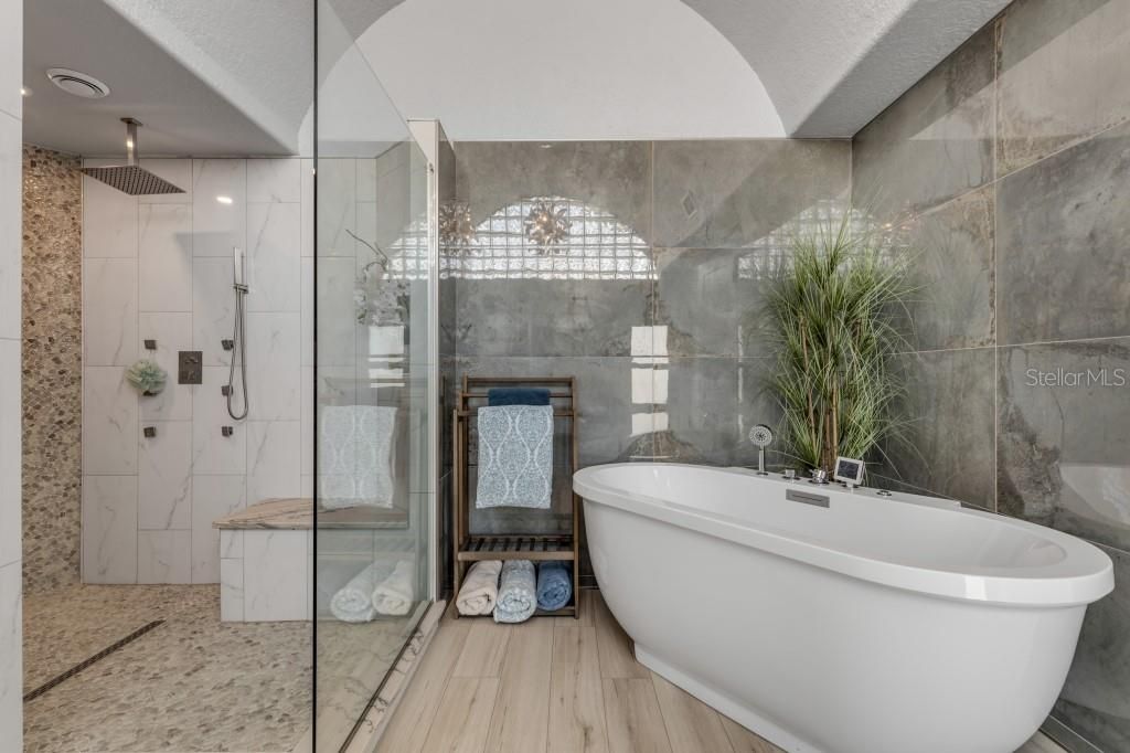 Bathroom, Free Standing Baths, Glass Shower, Interior, Recessed Lighting, Wood Texture Flooring