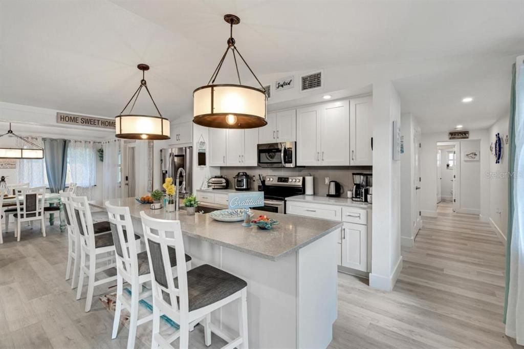 Dining room, Interior, Kitchen, Pendant Lights, Recessed Lighting, Stainless Steel Appliances, Wood Texture Flooring