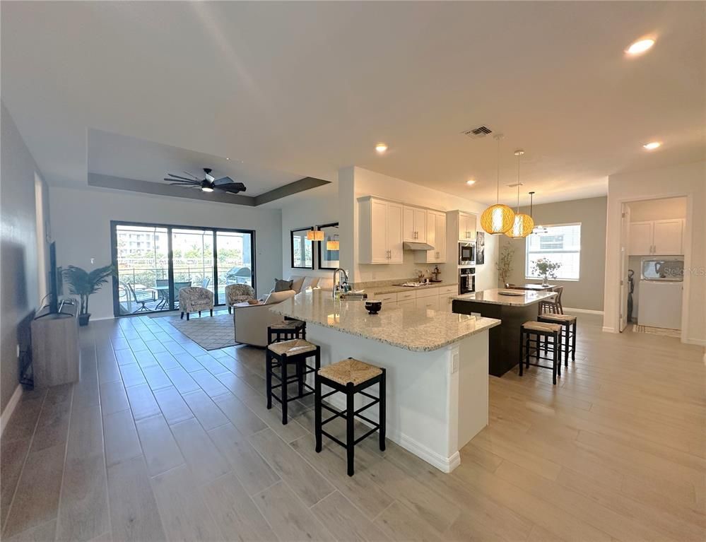 Dining room, Interior, Kitchen, Living room, Pendant Lights, Recessed Lighting, Stainless Steel Appliances, Wood Texture Flooring