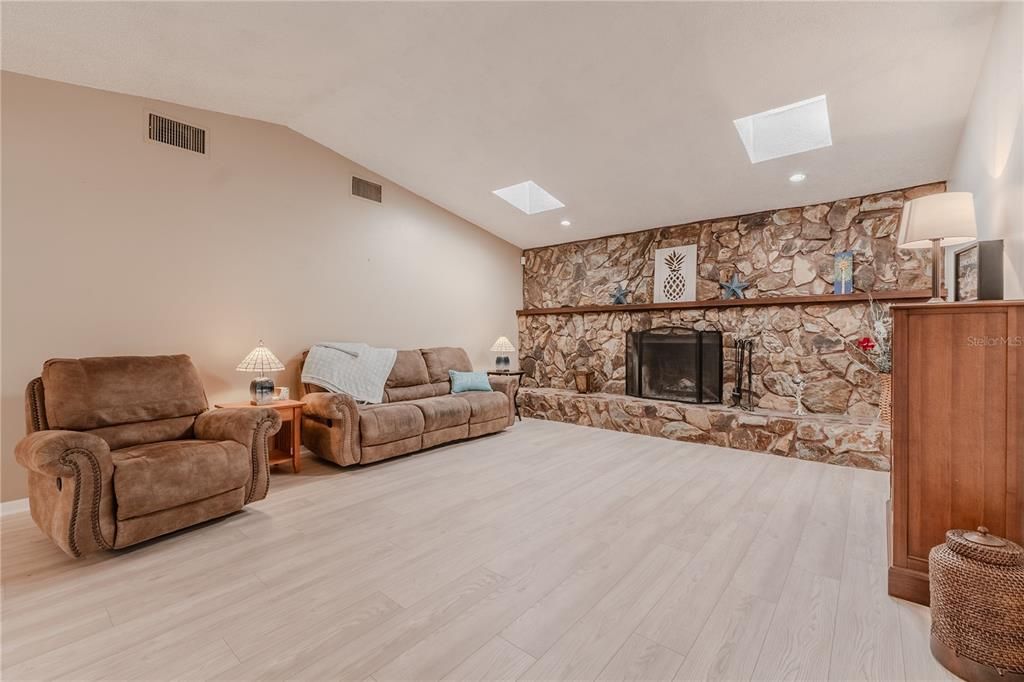 Fireplace, Interior, Living room, Recessed Lighting, Stone Walls, Wood Texture Flooring