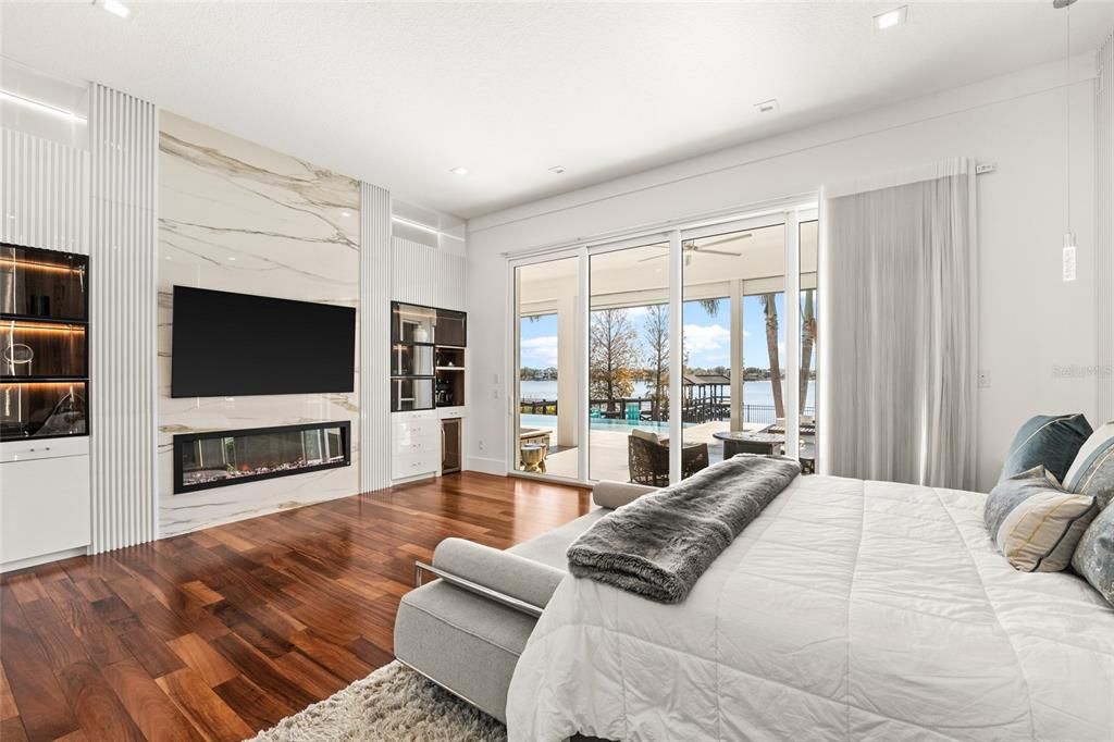 Bedroom, Fireplace, Interior, Marble Walls, Recessed Lighting, Water, Wood Texture Flooring