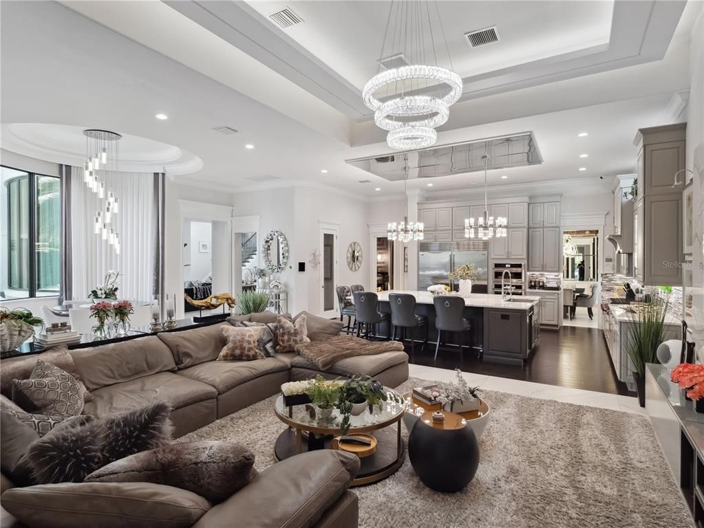 Chandelier, Dining room, Interior, Kitchen, Living room, Pendant Lights, Recessed Lighting, Stainless Steel Appliances, Wood Texture Flooring
