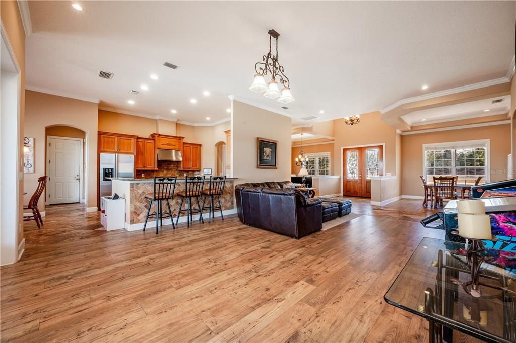 Chandelier, Dining room, Interior, Kitchen, Living room, Pendant Lights, Recessed Lighting, Stainless Steel Appliances, Wood Texture Flooring