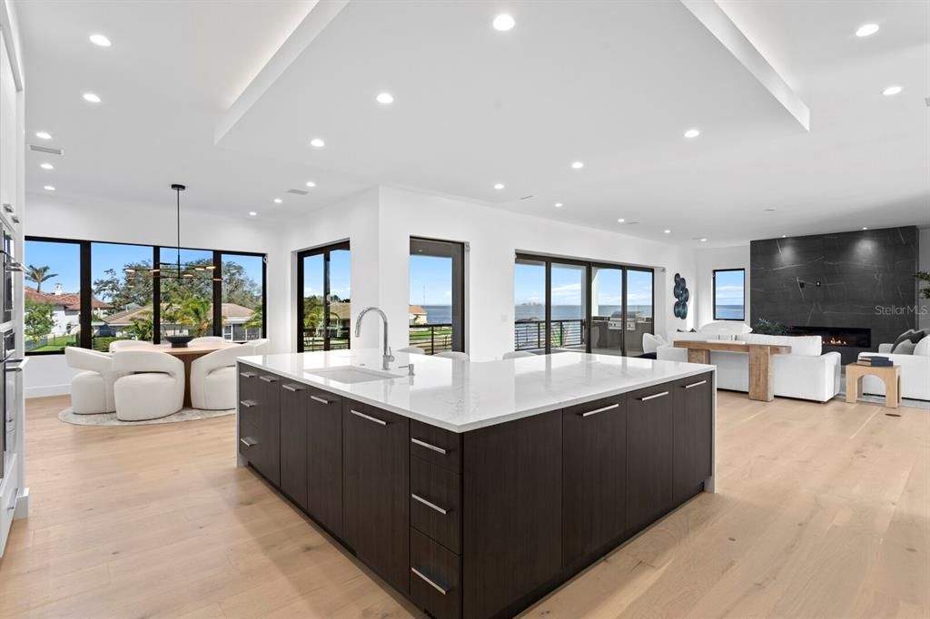 Dining room, Fireplace, Interior, Kitchen, Living room, Pendant Lights, Recessed Lighting, Water, Wood Texture Flooring