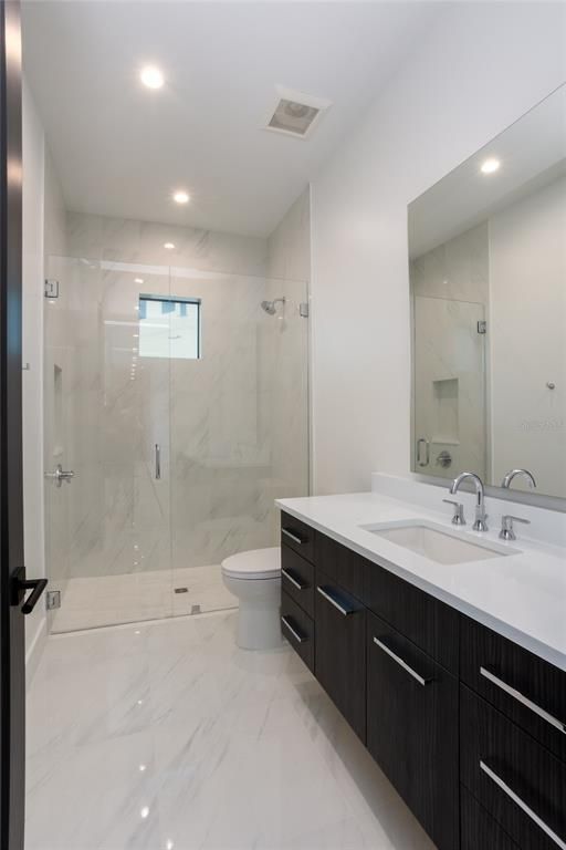 Bathroom, Dual Sink Vanities, Glass Shower, Interior, Marble, Marble Walls, Recessed Lighting