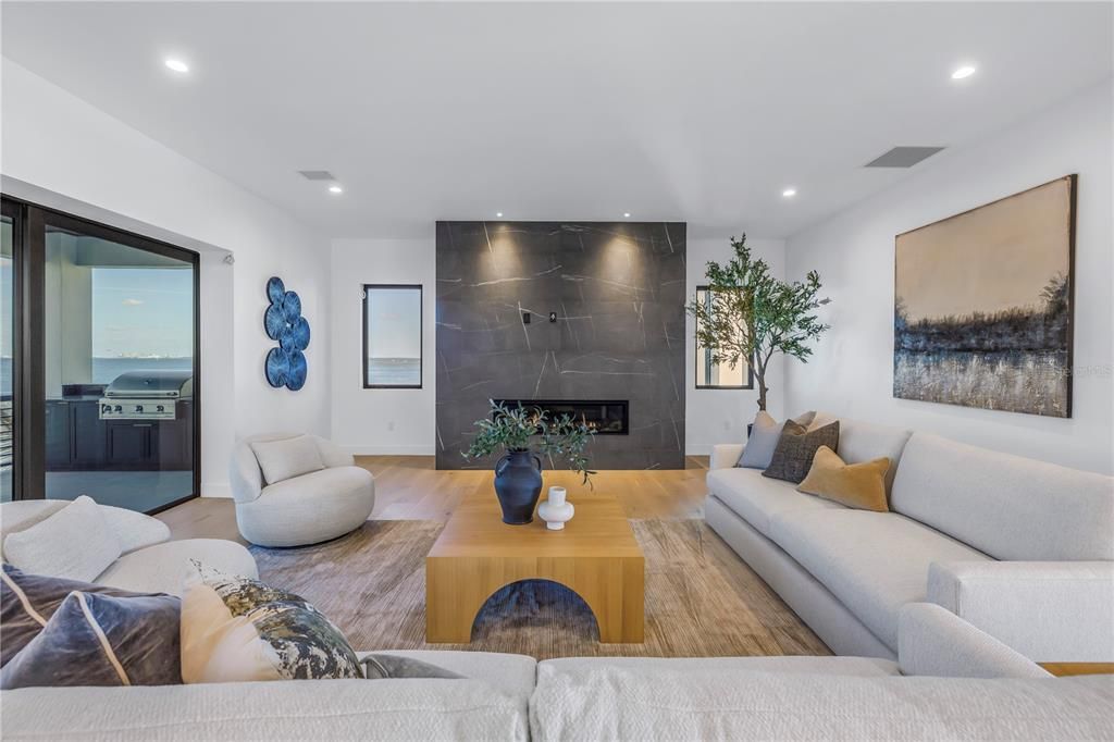 Fireplace, Interior, Living room, Marble Walls, Recessed Lighting, Wood Texture Flooring