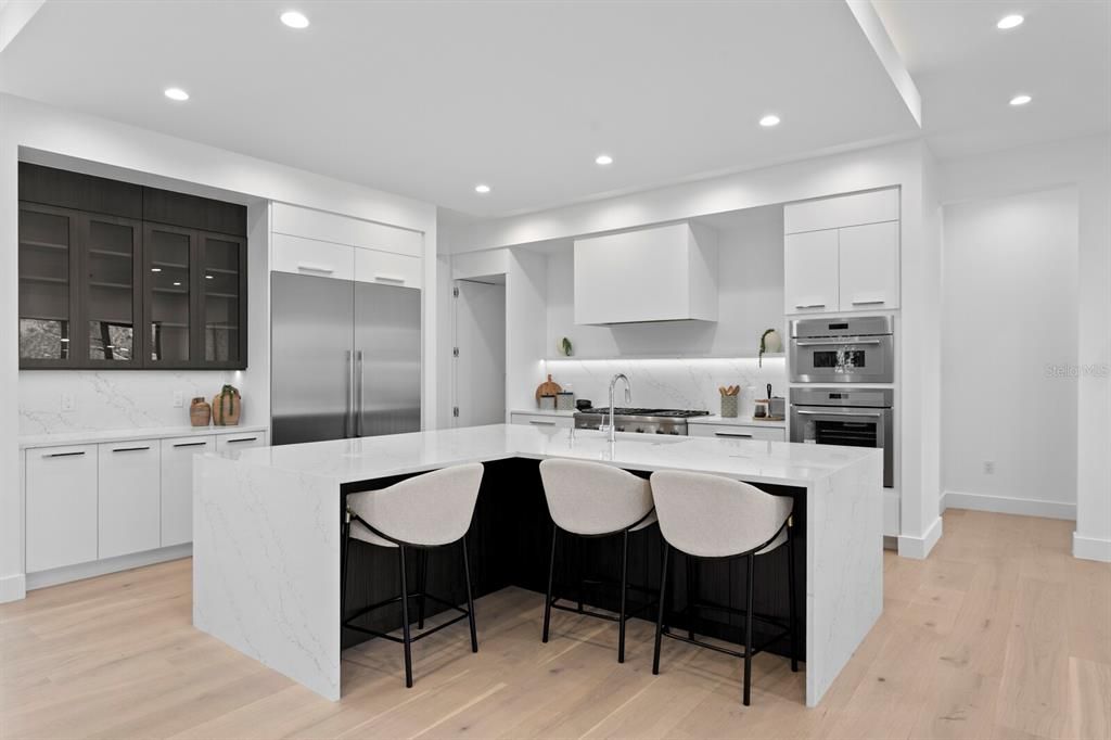 Interior, Kitchen, Marble Walls, Recessed Lighting, Stainless Steel Appliances, Wood Texture Flooring