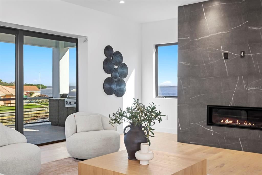 Fireplace, Interior, Marble Walls, Recessed Lighting, Water, Wood Texture Flooring