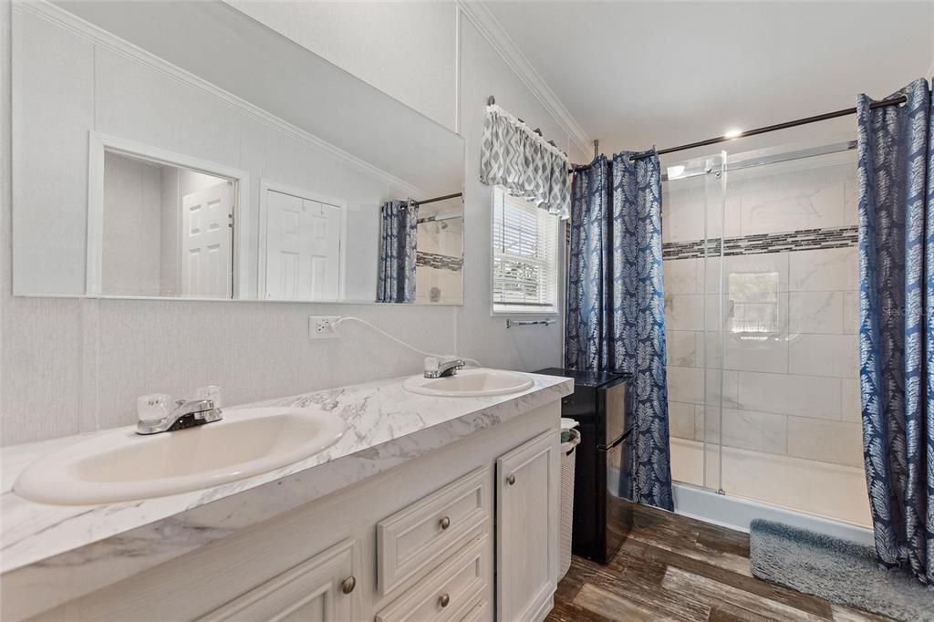 Bathroom, Dual Sink Vanities, Glass Shower, Interior, Marble Walls, Wood Texture Flooring
