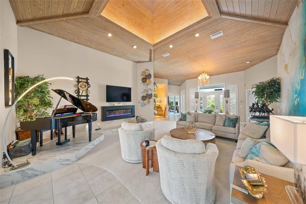 Chandelier, Fireplace, Interior, Living room, Piano, Recessed Lighting, Wooden Ceilings
