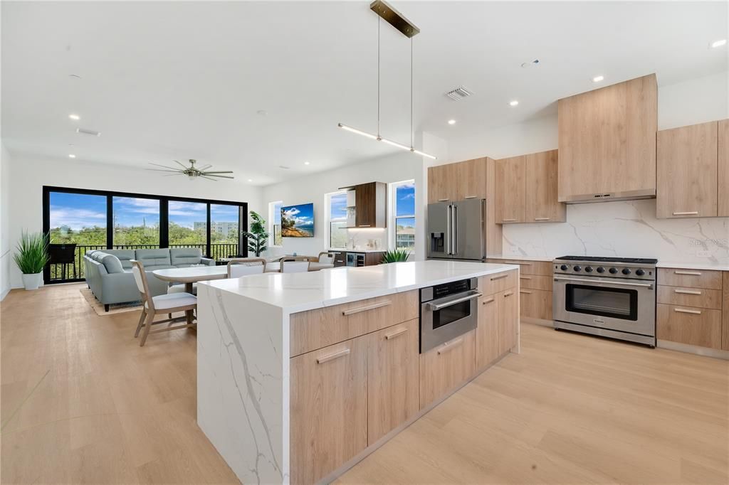Dining room, Interior, Kitchen, Living room, Pendant Lights, Recessed Lighting, Stainless Steel Appliances, Water, Wood Texture Flooring