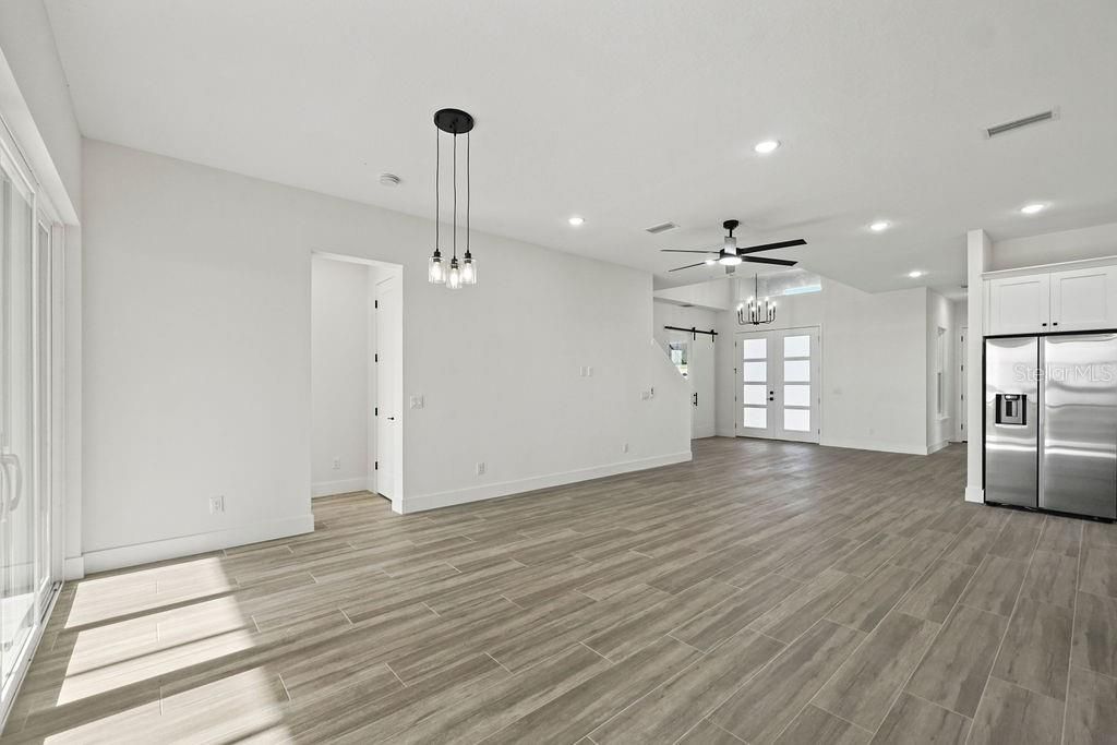 Empty room, Interior, Kitchen, Pendant Lights, Recessed Lighting, Stainless Steel Appliances, Wood Texture Flooring