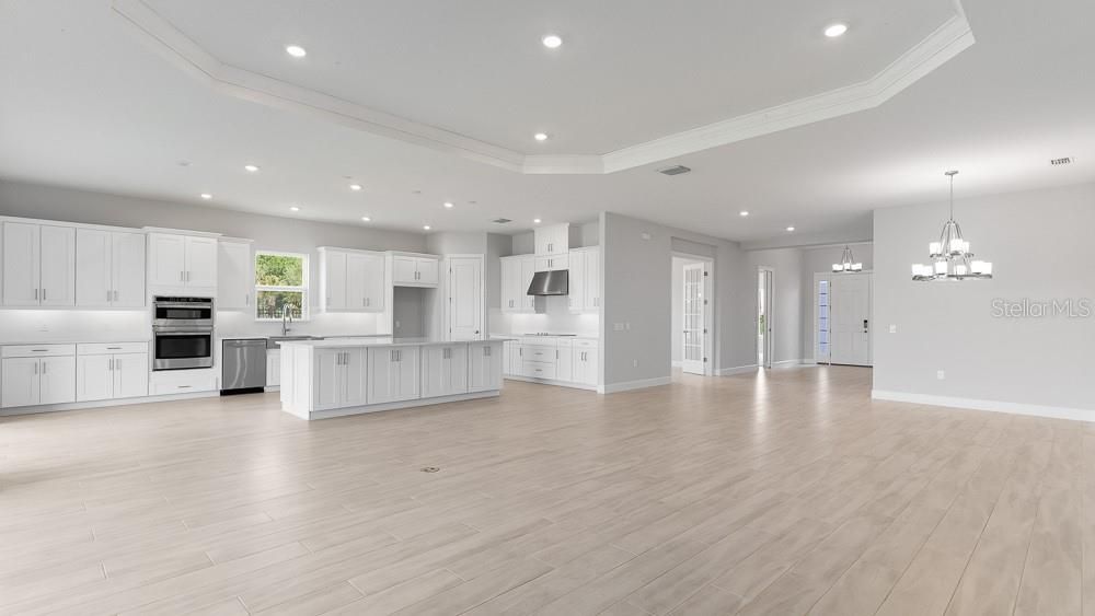 Chandelier, Empty room, Interior, Kitchen, Recessed Lighting, Stainless Steel Appliances, Wood Texture Flooring