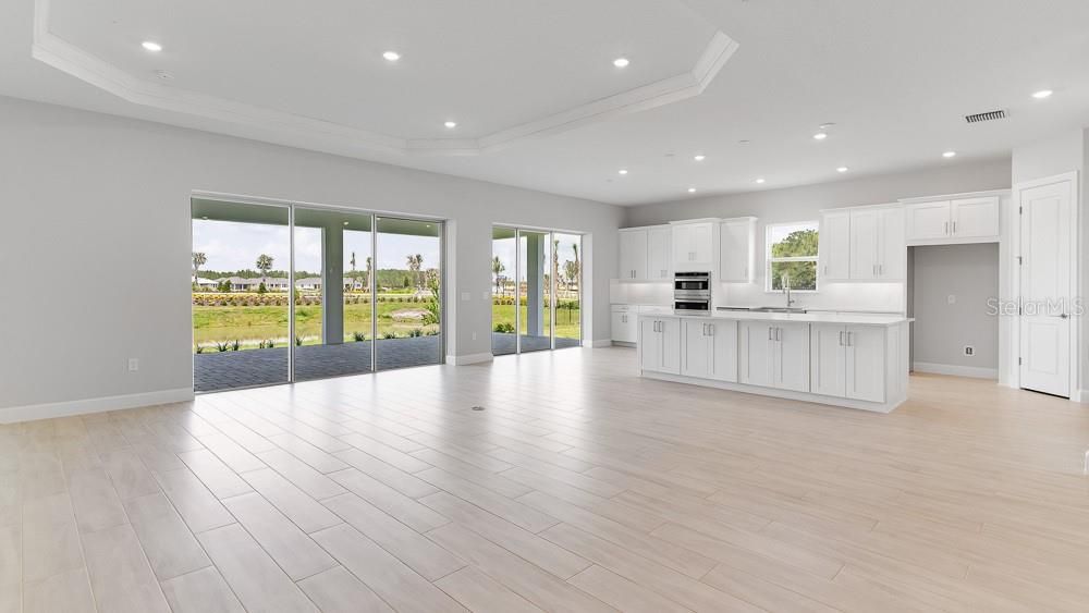 Empty room, Interior, Kitchen, Recessed Lighting, Stainless Steel Appliances, Wood Texture Flooring