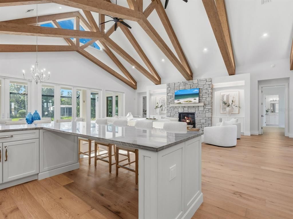 Chandelier, Dining room, Fireplace, Interior, Living room, Pendant Lights, Recessed Lighting, Wooden Beams, Wood Texture Flooring