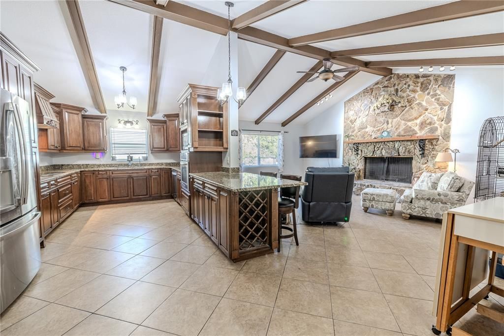 Fireplace, Interior, Kitchen, Living room, Pendant Lights, Stainless Steel Appliances, Stone Walls, Wooden Beams