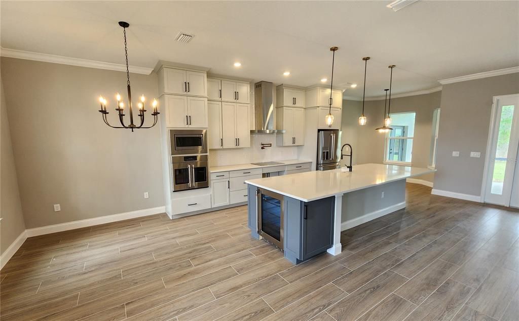 Chandelier, Interior, Kitchen, Pendant Lights, Recessed Lighting, Stainless Steel Appliances, Wood Texture Flooring