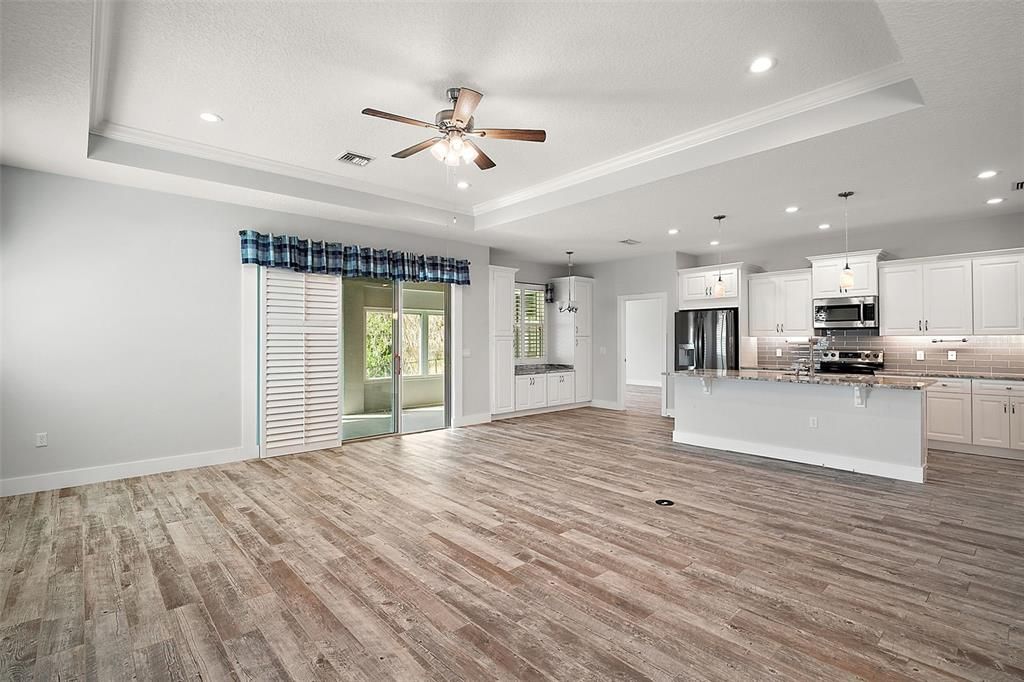 Empty room, Interior, Kitchen, Pendant Lights, Recessed Lighting, Stainless Steel Appliances, Wood Texture Flooring