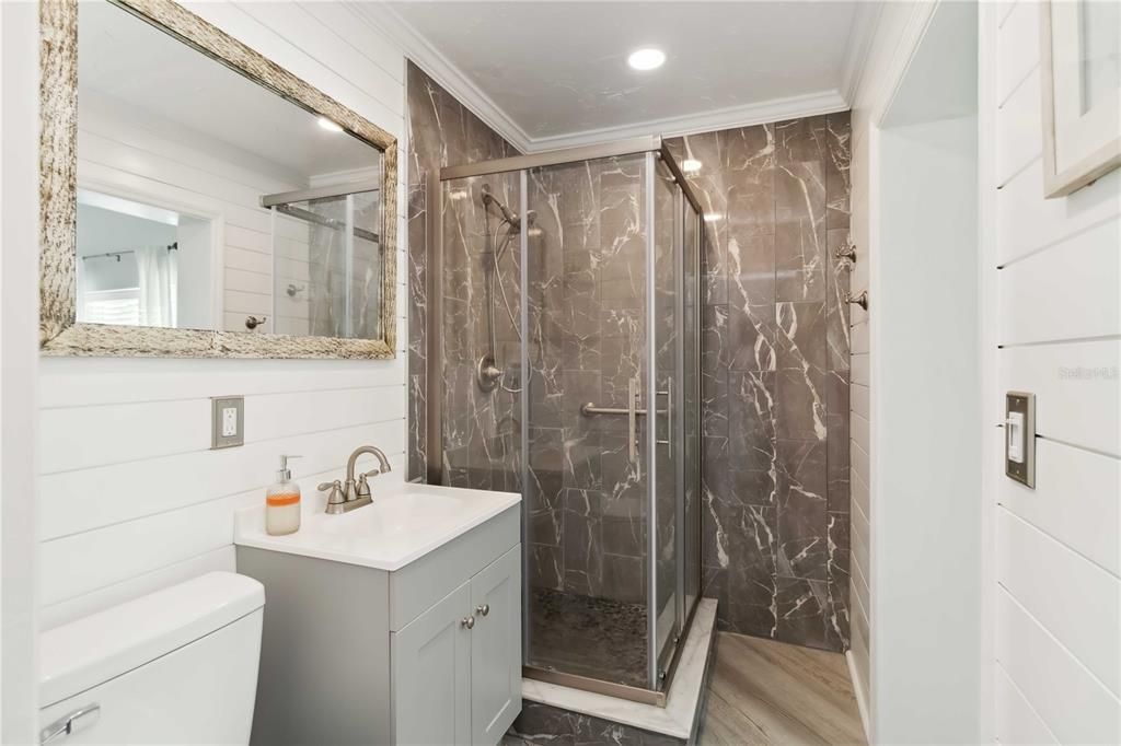 Bathroom, Glass Shower, Interior, Marble Walls, Recessed Lighting, Wood Texture Flooring