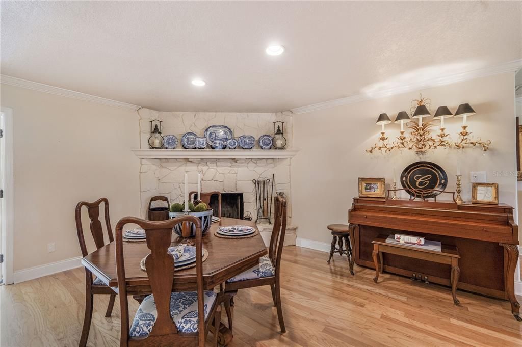 Dining room, Fireplace, Interior, Piano, Recessed Lighting, Wood Texture Flooring