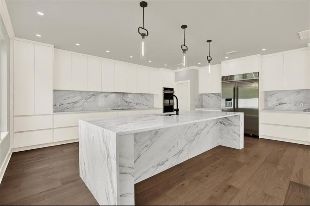 Interior, Kitchen, Marble Walls, Pendant Lights, Recessed Lighting, Stainless Steel Appliances, Wood Texture Flooring