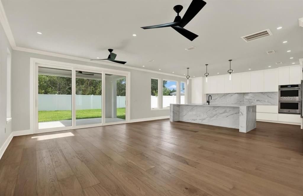 Interior, Kitchen, Marble Walls, Pendant Lights, Recessed Lighting, Stainless Steel Appliances, Wood Texture Flooring