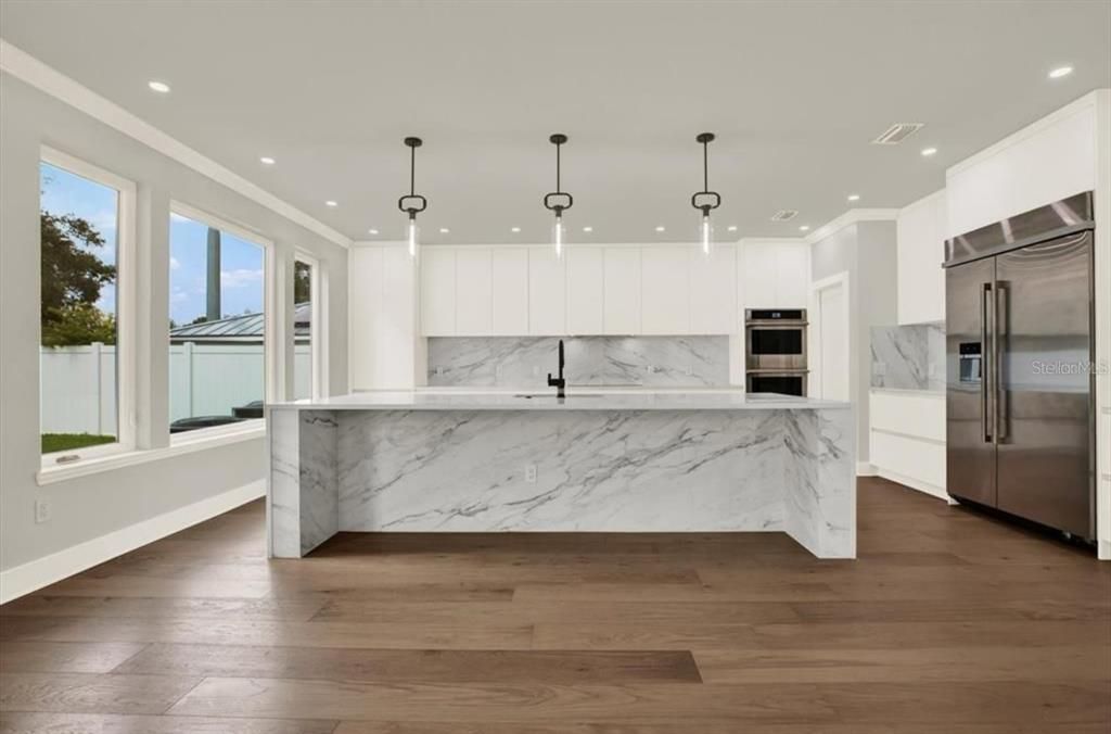 Interior, Kitchen, Marble Walls, Pendant Lights, Recessed Lighting, Stainless Steel Appliances, Wood Texture Flooring