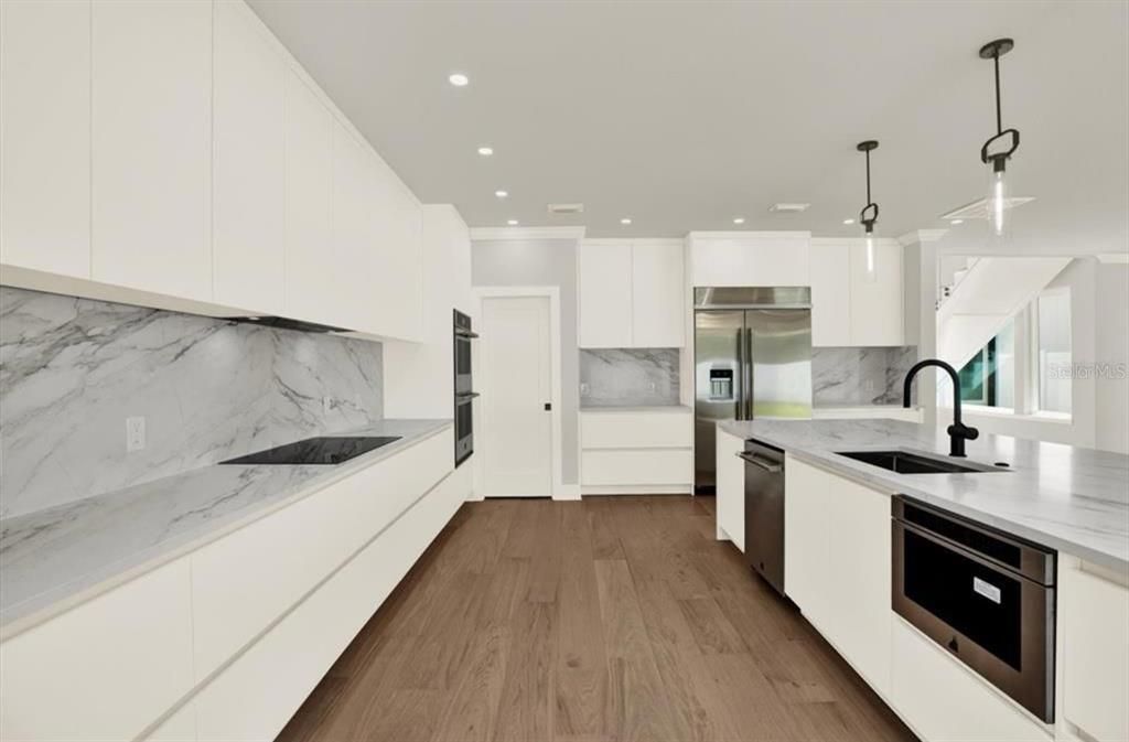 Interior, Kitchen, Marble Walls, Pendant Lights, Recessed Lighting, Stainless Steel Appliances, Wood Texture Flooring