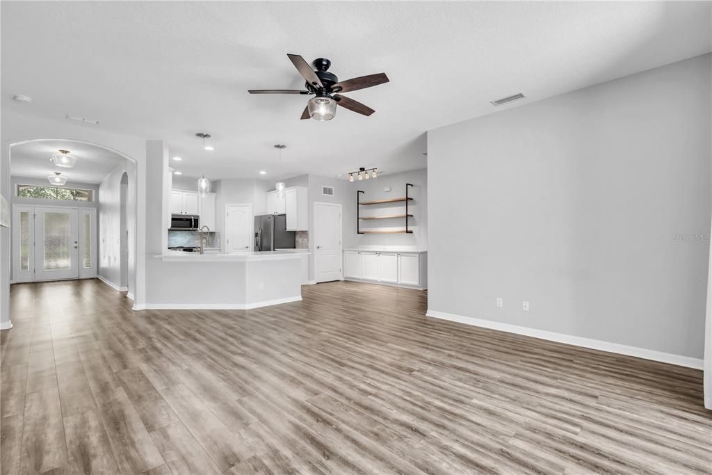 Empty room, Interior, Kitchen, Pendant Lights, Recessed Lighting, Stainless Steel Appliances, Wood Texture Flooring