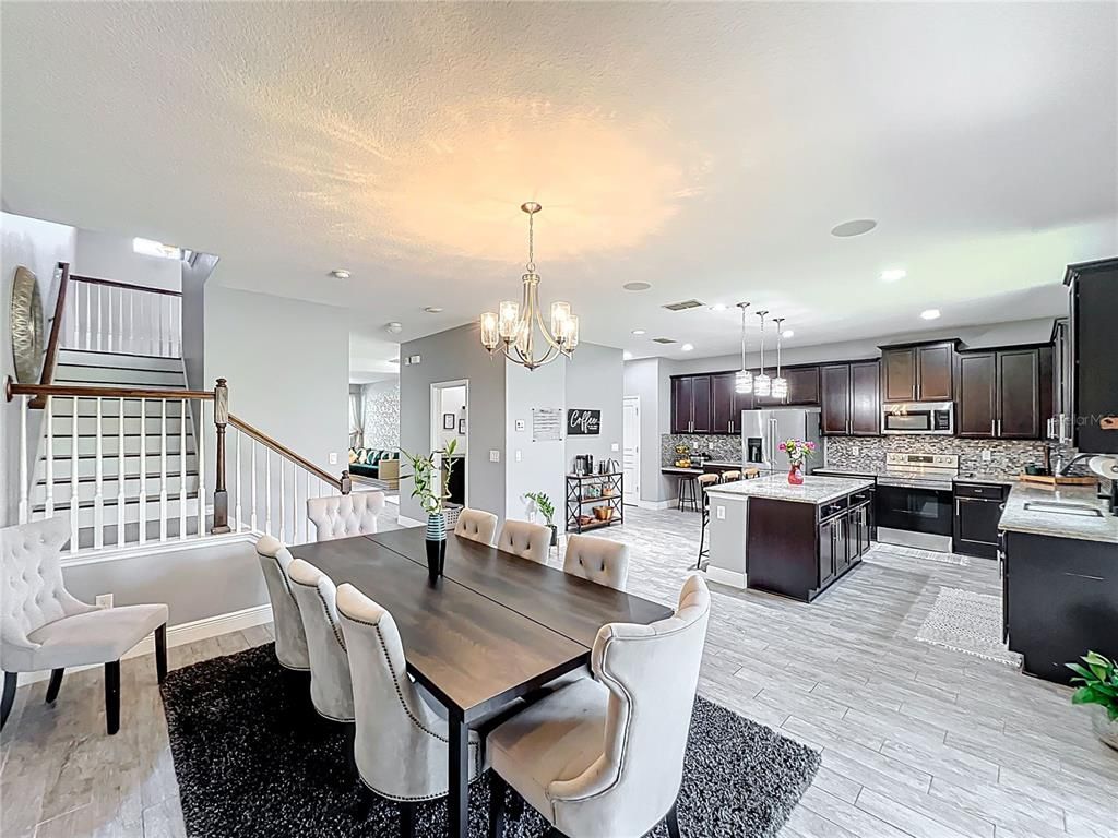 Chandelier, Dining room, Interior, Kitchen, Pendant Lights, Recessed Lighting, Stainless Steel Appliances, Wood Texture Flooring