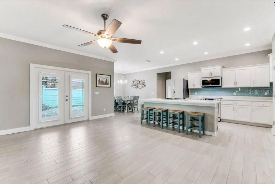 Dining room, Interior, Kitchen, Pendant Lights, Recessed Lighting, Stainless Steel Appliances, Wood Texture Flooring
