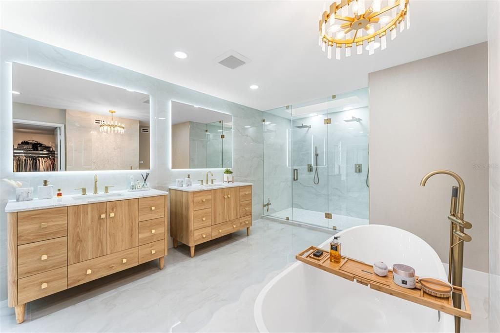 Bathroom, Chandelier, Dual Sink Vanities, Free Standing Baths, Glass Shower, Interior, Marble, Marble Walls, Recessed Lighting