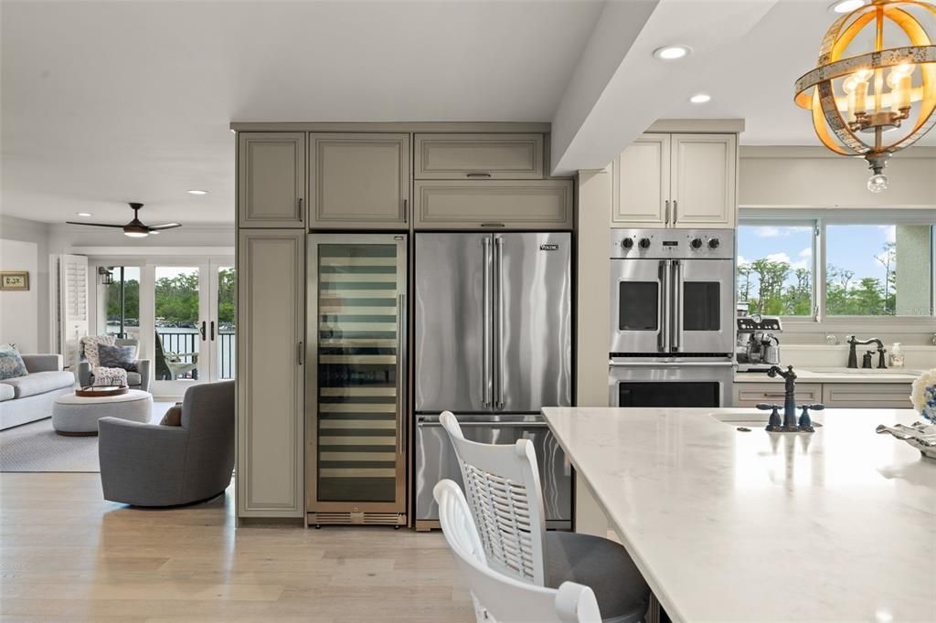 Chandelier, Interior, Kitchen, Living room, Pendant Lights, Recessed Lighting, Stainless Steel Appliances, Wood Texture Flooring