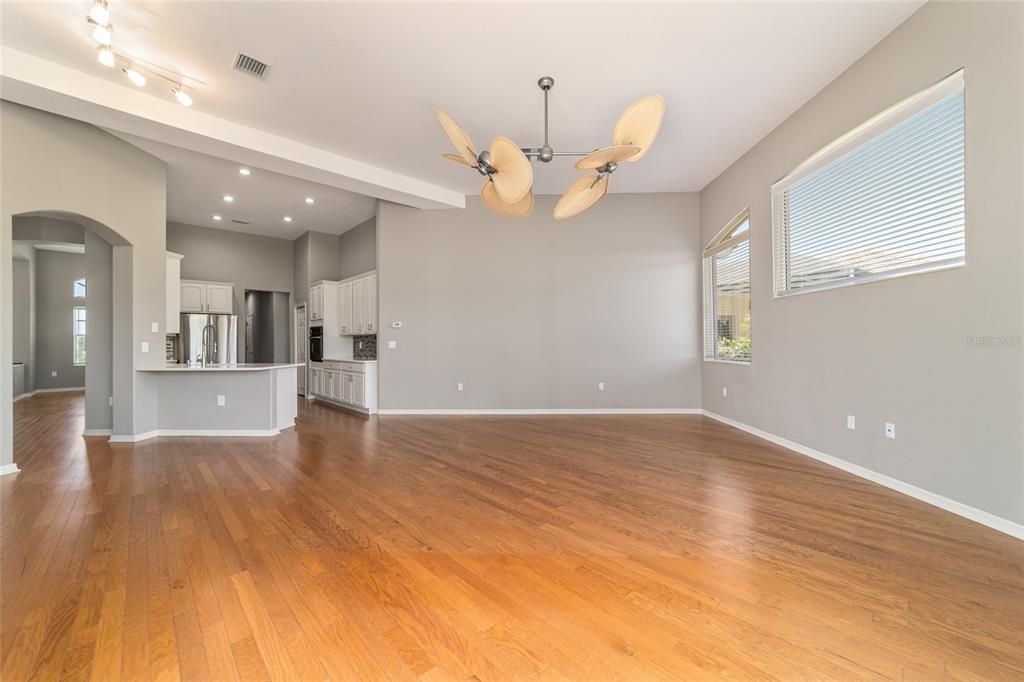 Empty room, Interior, Kitchen, Recessed Lighting, Stainless Steel Appliances, Wood Texture Flooring