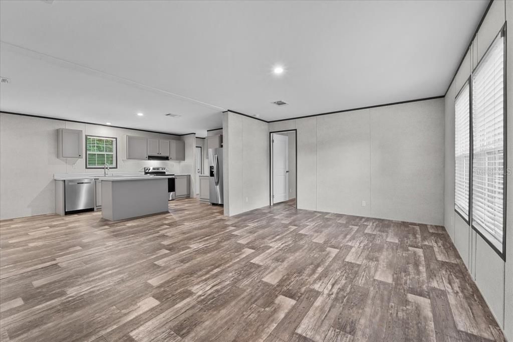 Empty room, Interior, Kitchen, Recessed Lighting, Stainless Steel Appliances, Wood Texture Flooring